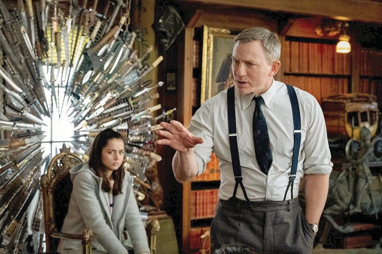 This image released by Lionsgate shows Ana de Armas, left, and Daniel Craig in a scene from "Knives Out." (Claire Folger/Lionsgate via AP)